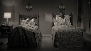 A couple of beds in a room
Description automatically generated with medium confidence